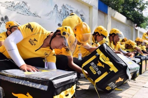 Meituan couriers prepare for food delivery. (Photo/Xinhua)
