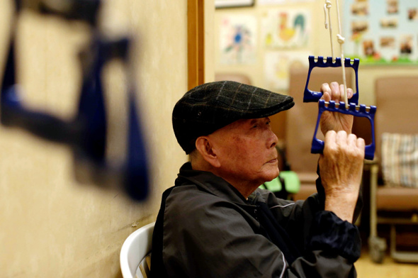 An elderly Culture Homes resident exercises in an area designated for working out. ��Photo: China Daily/Roy Liu��