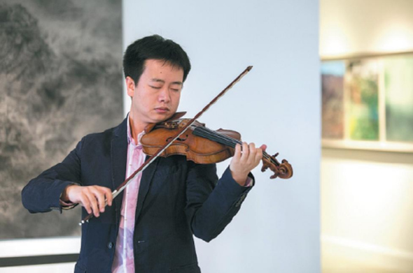 Beijing-based legal consultant and amateur violinist Zhang Maolun plays the Italian Carrassi violin owned by renowned Chinese violinist Liu Xiao, which is the target of a violin crowdfunding program launched by Zhang and his friend. ��Photo provided to China Daily��