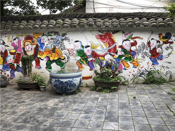 Colorful and vivid traditional Chinese New Year paintings are seen on the wall of a residence at Nianhua village in Xiaode town, Mianzhu city, Southwest China��s Sichuan province, May 5, 2018. (Photo by Yao Yao/chinadaily.com.cn)