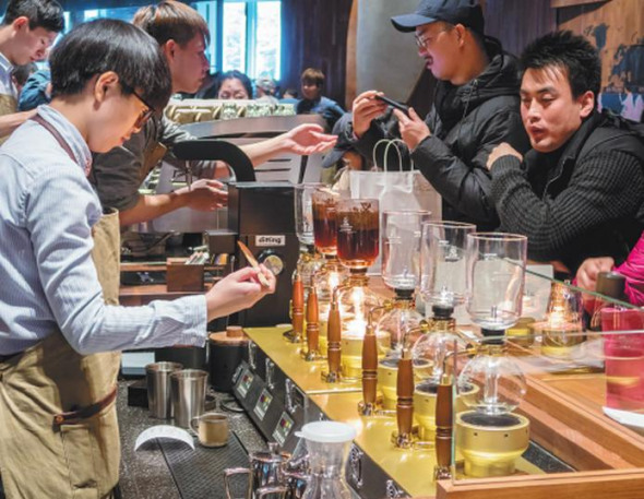 Baristas prepare customers' orders at Shanghai Roastery, Starbucks' first international roastery, on Dec 6, 2017. ��Photo by Wang Gang/For China Daily��