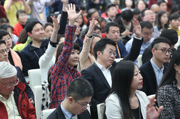 Reporters hope to be called on at a news conference for the first session of the 13th National Committee of the Chinese People's Political Consultative Conference at the Great Hall of the People in Beijing. The session begins on Saturday. (Photo/Xinhua��